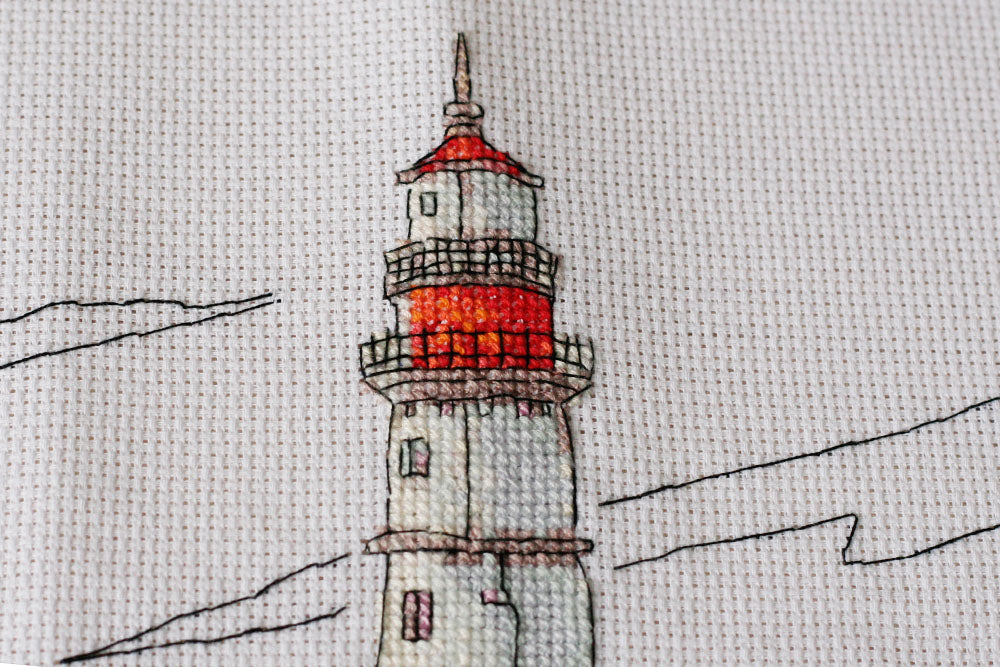 Cross-stitch kit Lighthouse light AH-109 featuring cotton canvas, colorful floss, and needles for crafting.