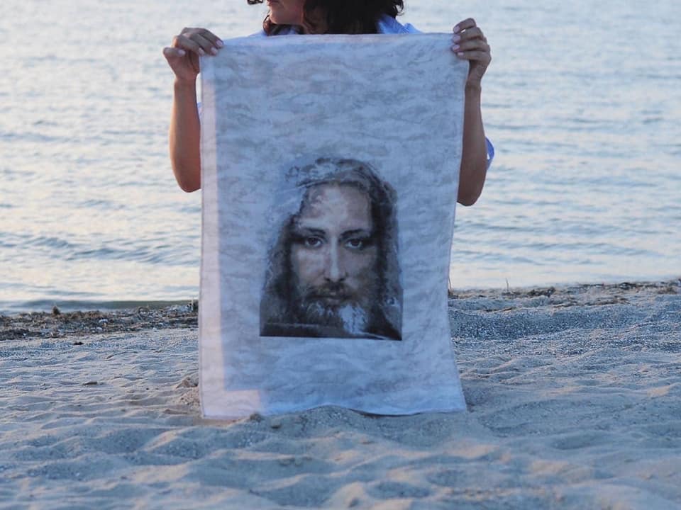 Cross-stitch kit M-202C featuring the Turin Shroud design, including fabric, threads, and instructions.