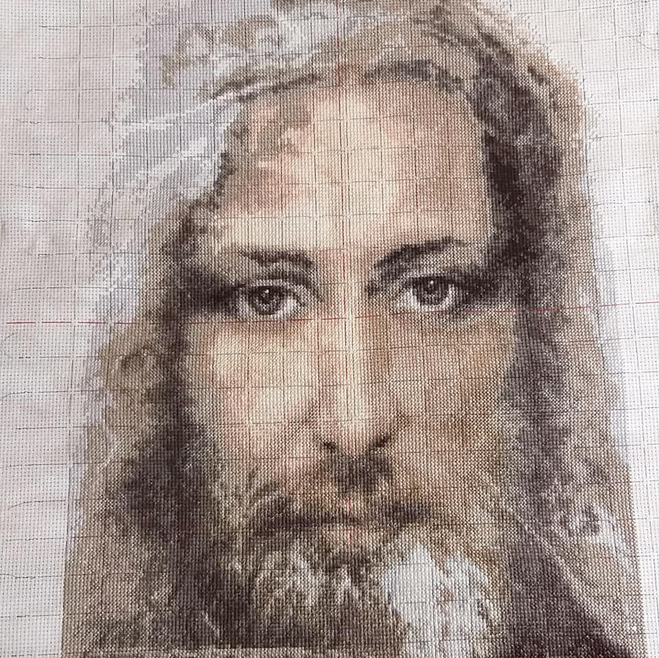 Cross-stitch kit M-202C featuring the Turin Shroud design, including fabric, threads, and instructions.