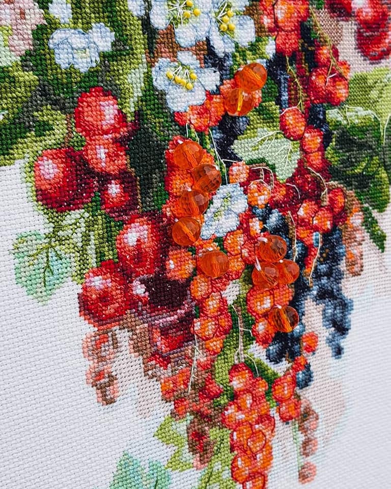 Cross-stitch kit M-266C 'Sweet berry' featuring colorful threads, Aida fabric, beads, and a needle, perfect for embroidery enthusiasts.