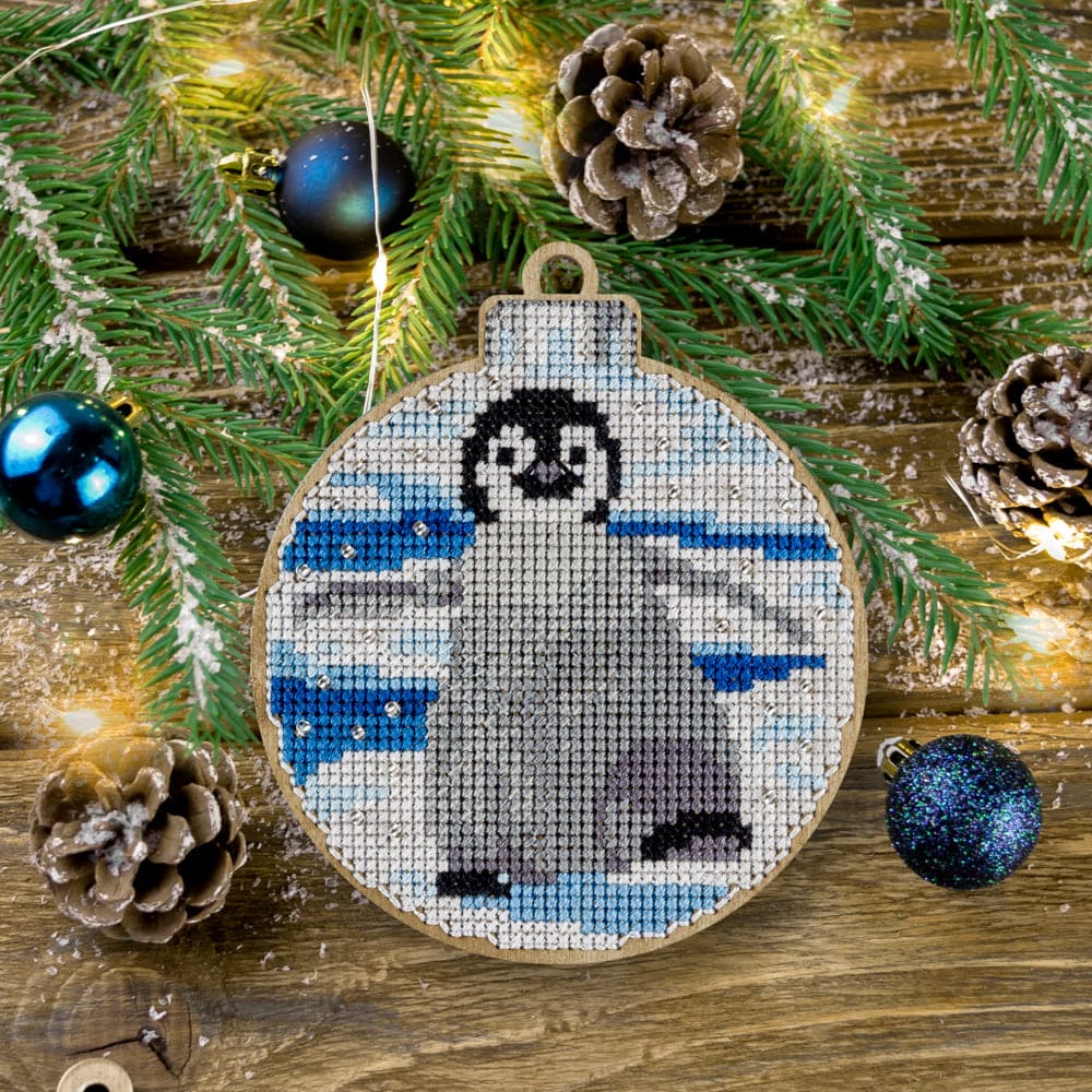 Cross-stitch kit on wood FLW-013 featuring a perforated plywood blank, colorful threads, beads, and embroidery tools for festive decorations.