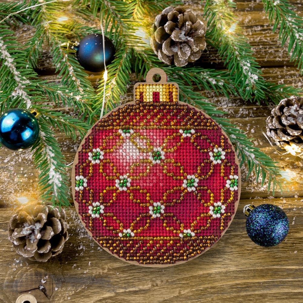 Cross-stitch kit on wood FLW-021 featuring a plywood blank, colorful threads, beads, and crafting tools for Christmas decorations.