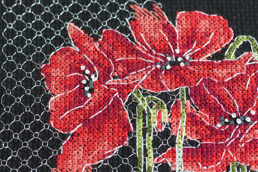 Cross-stitch kit Poppies AH-138 featuring black cotton canvas, colorful floss, and metallic thread for vibrant stitching.