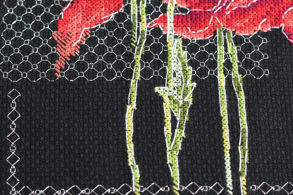 Cross-stitch kit Poppies AH-138 featuring black cotton canvas, colorful floss, and metallic thread for vibrant stitching.