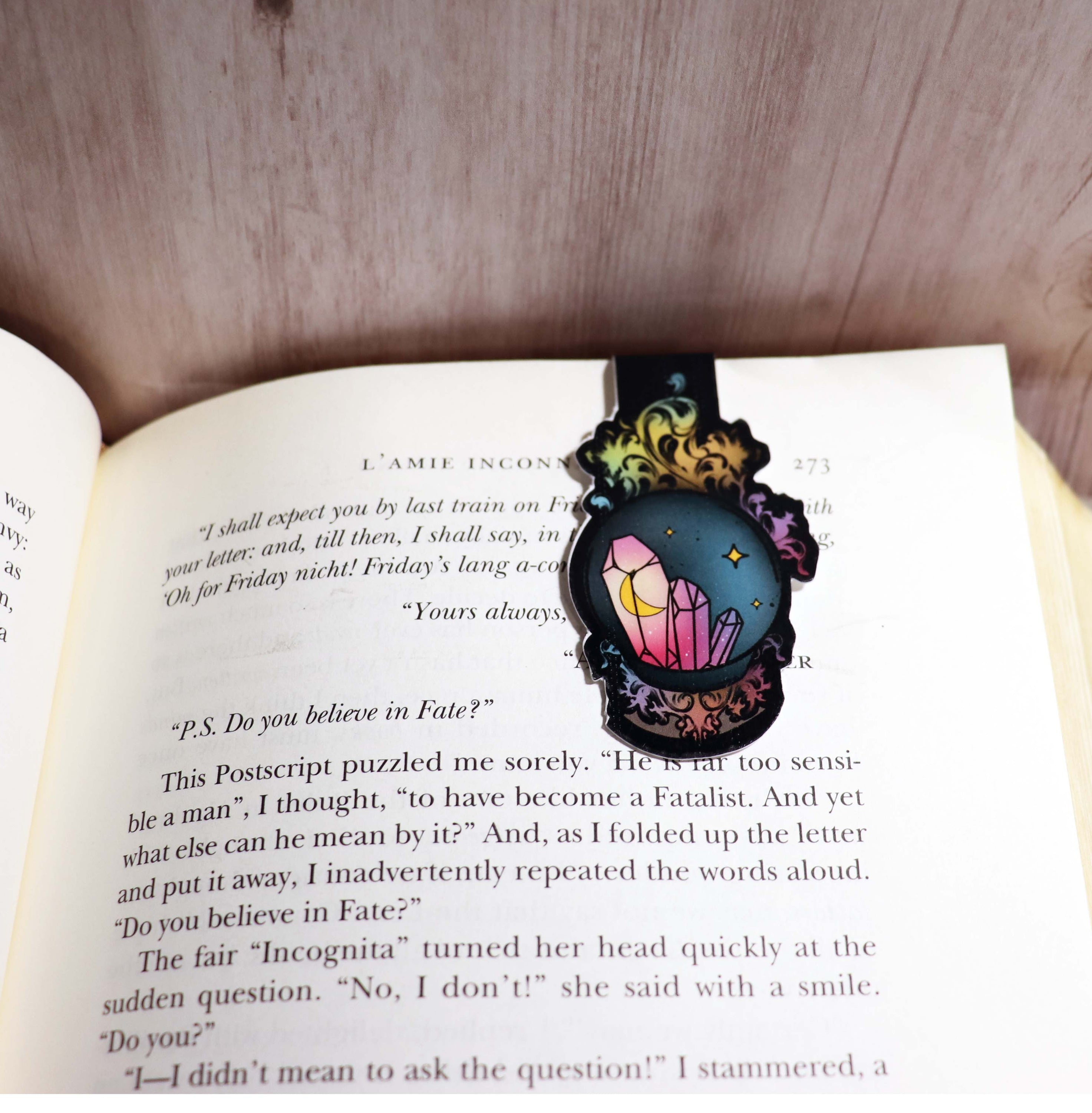 A beautifully designed Crystal Ball Bookmark featuring a double-sided print with vibrant colors and strong magnets for secure page holding.