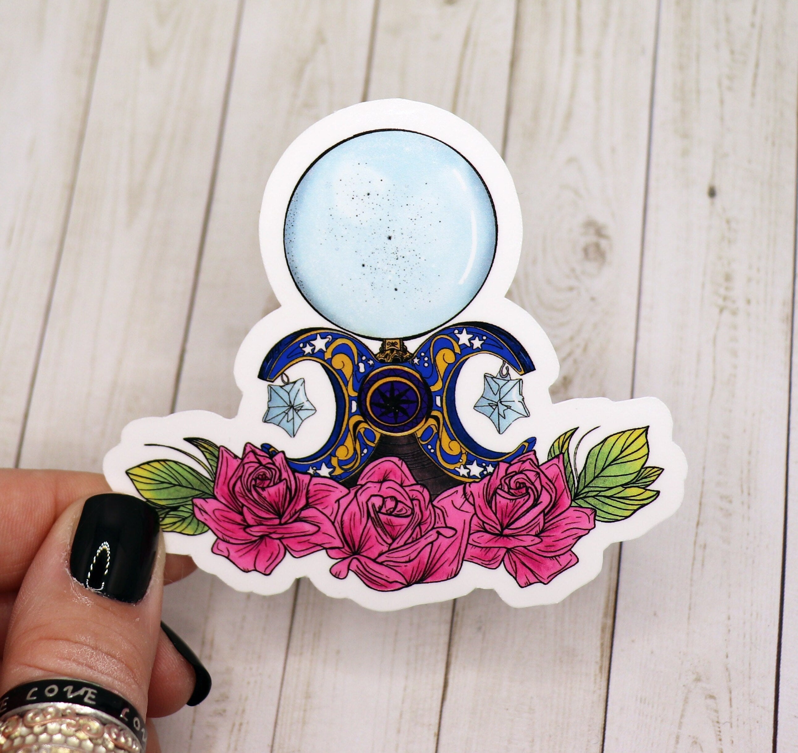 A vibrant Crystal Ball Vinyl Sticker featuring mystical designs, perfect for personalizing various items.