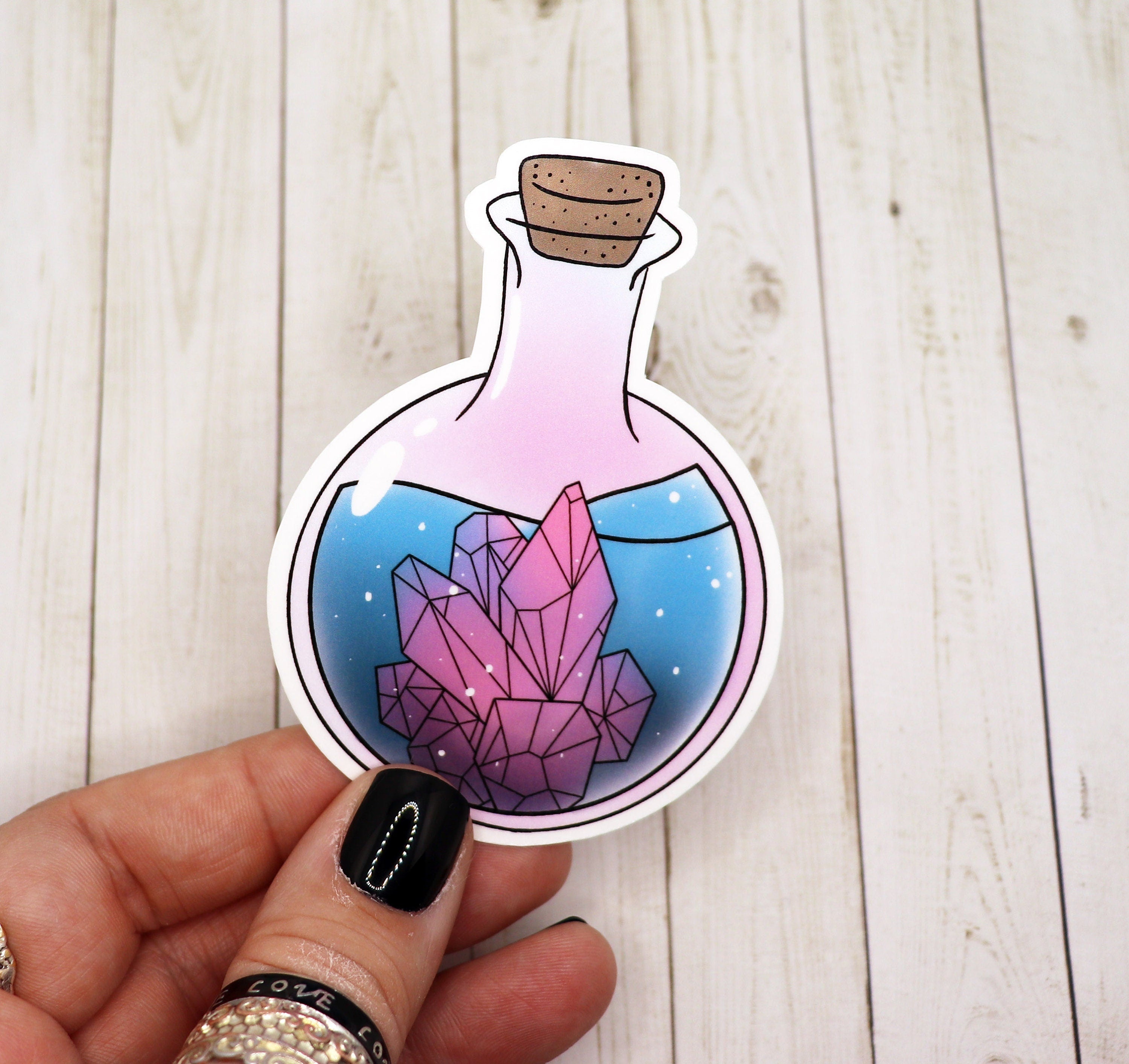 A vibrant Crystal Potion Bottle Sticker featuring a magical design, perfect for personalizing various items.