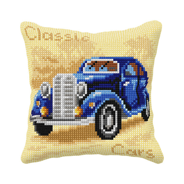 Cushion cross stitch kit featuring a blue car design, including printed canvas, colorful yarn, and stitching supplies.