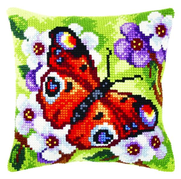 Cushion cross stitch kit featuring a butterfly design, including printed canvas, colorful yarn, needle, and instructions.