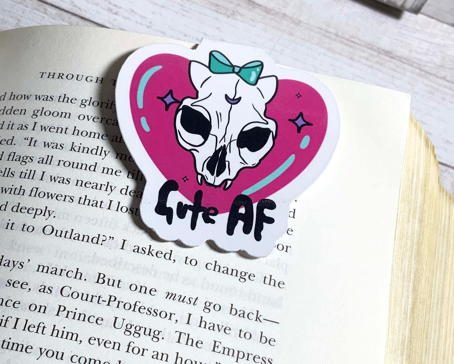 Cute AF Magnetic Bookmark featuring a stylish design, measuring 2.5 inches square, with strong magnets for holding multiple pages.