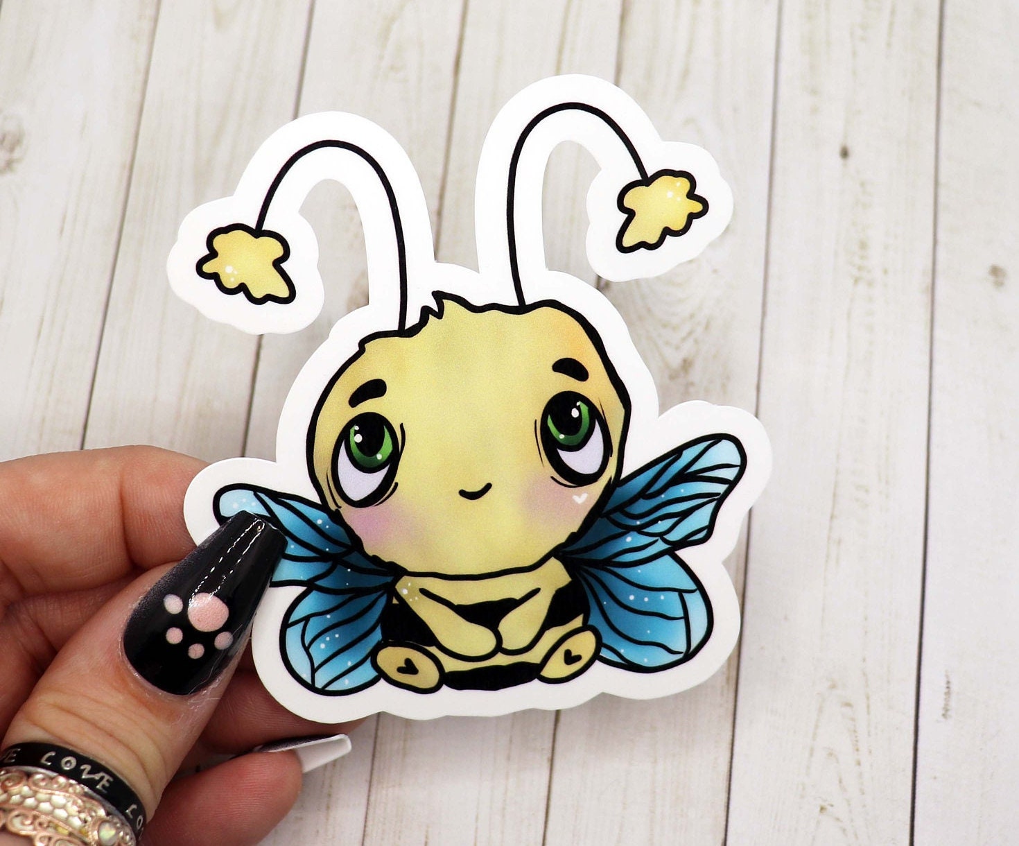 A cute bee sticker featuring a cheerful bee design, perfect for personalizing various items.