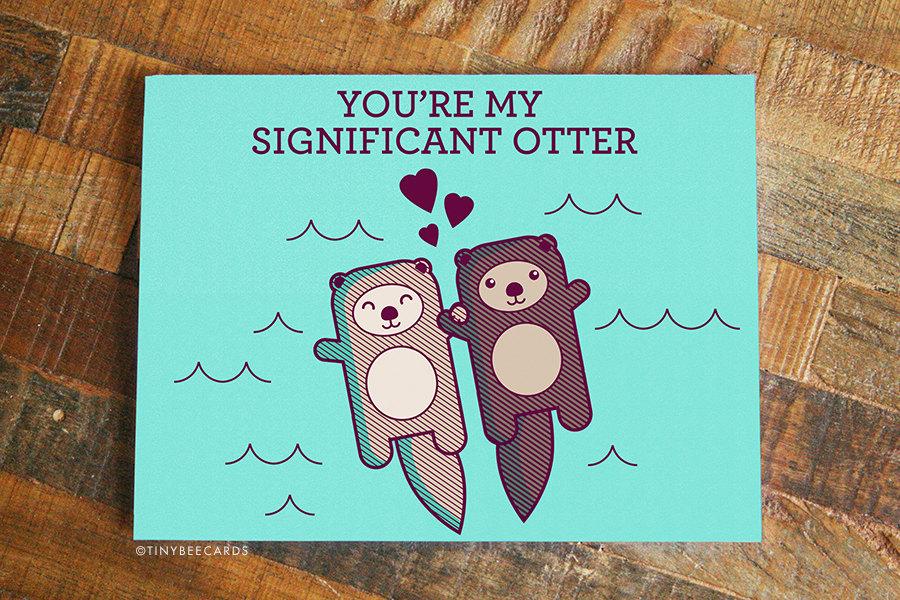 Cute greeting card featuring two otters holding hands, perfect for expressing love.