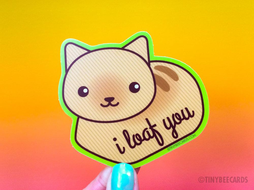 Cute vinyl sticker featuring a cat in a loaf position with the text 'I Loaf You'. Perfect for personalizing items.