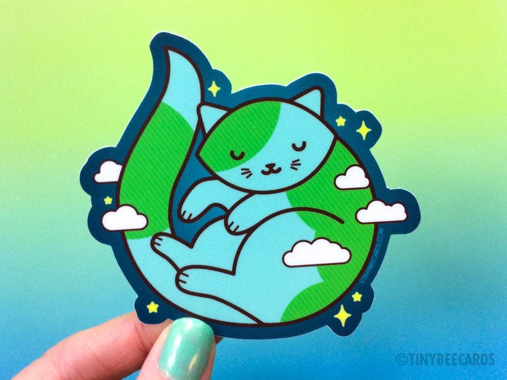 Cute Earth Cat Vinyl Sticker featuring a green and blue cat shaped like planet Earth with clouds and stars.