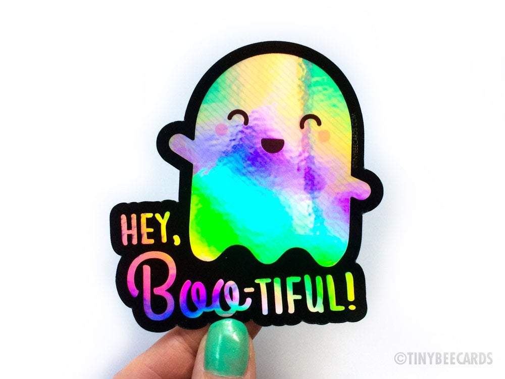 Cute holographic ghost vinyl sticker with the text 'You're Boo-tiful', featuring a playful ghost dinosaur design.