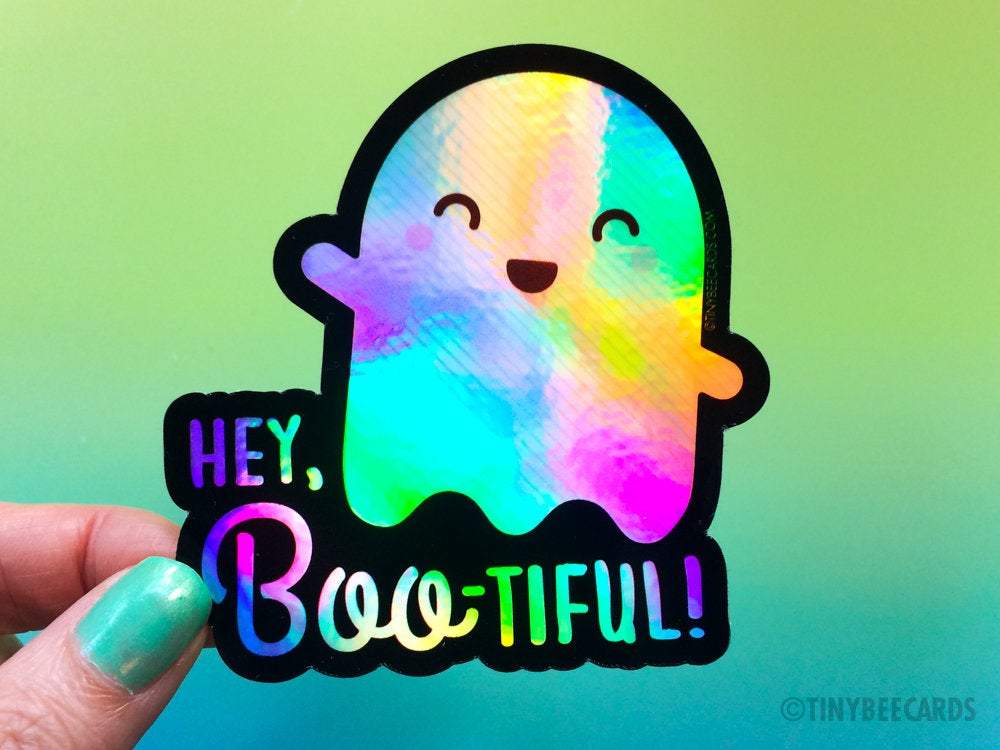 Cute holographic ghost vinyl sticker with the text 'You're Boo-tiful', featuring a playful ghost dinosaur design.