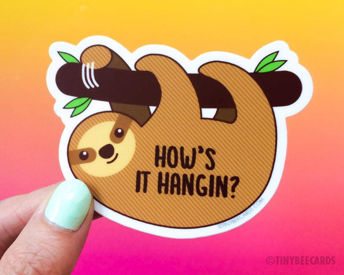 Cute sloth vinyl sticker with the pun 'How's It Hangin', featuring a sloth hanging on a branch.