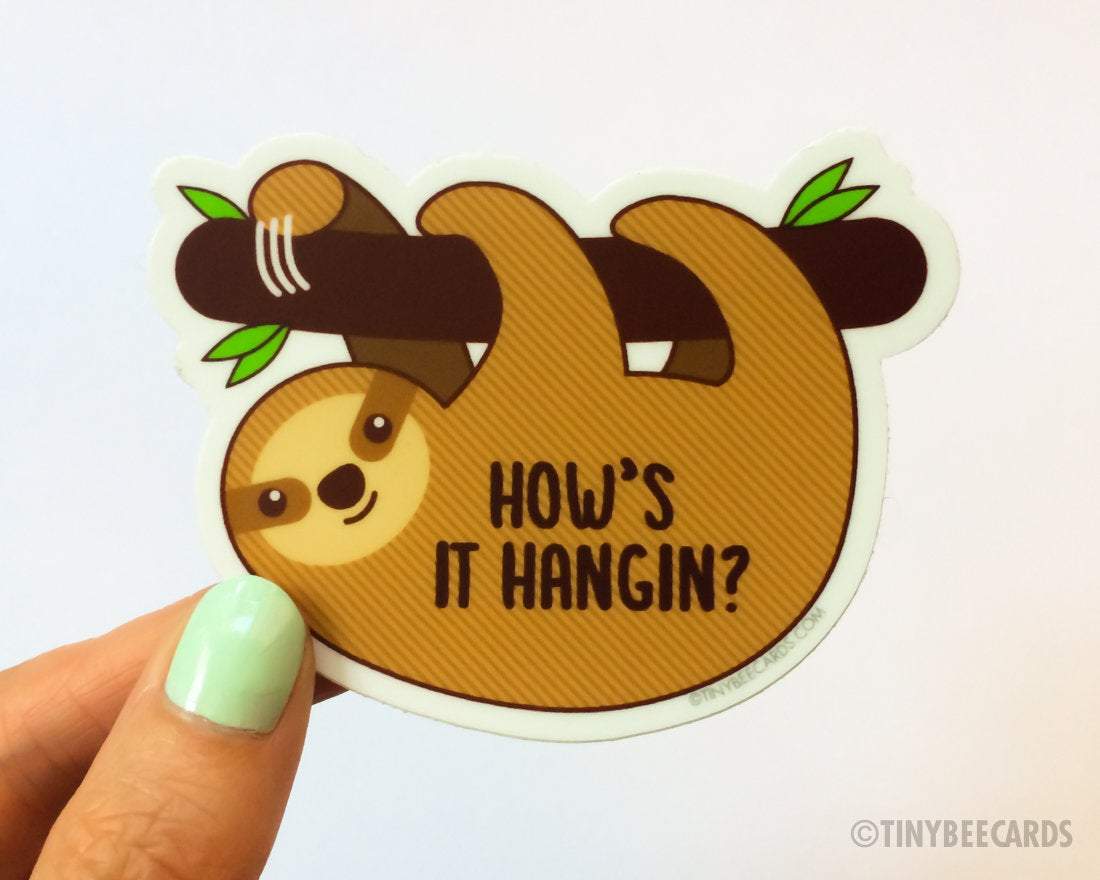 Cute sloth vinyl sticker with the pun 'How's It Hangin', featuring a sloth hanging on a branch.