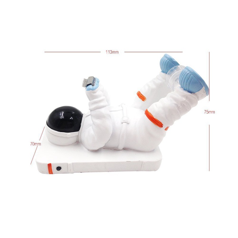 Astronaut figurine lying on smartphone.