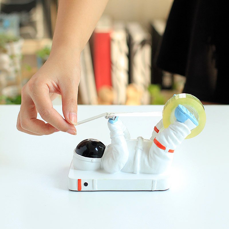 Astronaut-shaped tape dispenser holder.