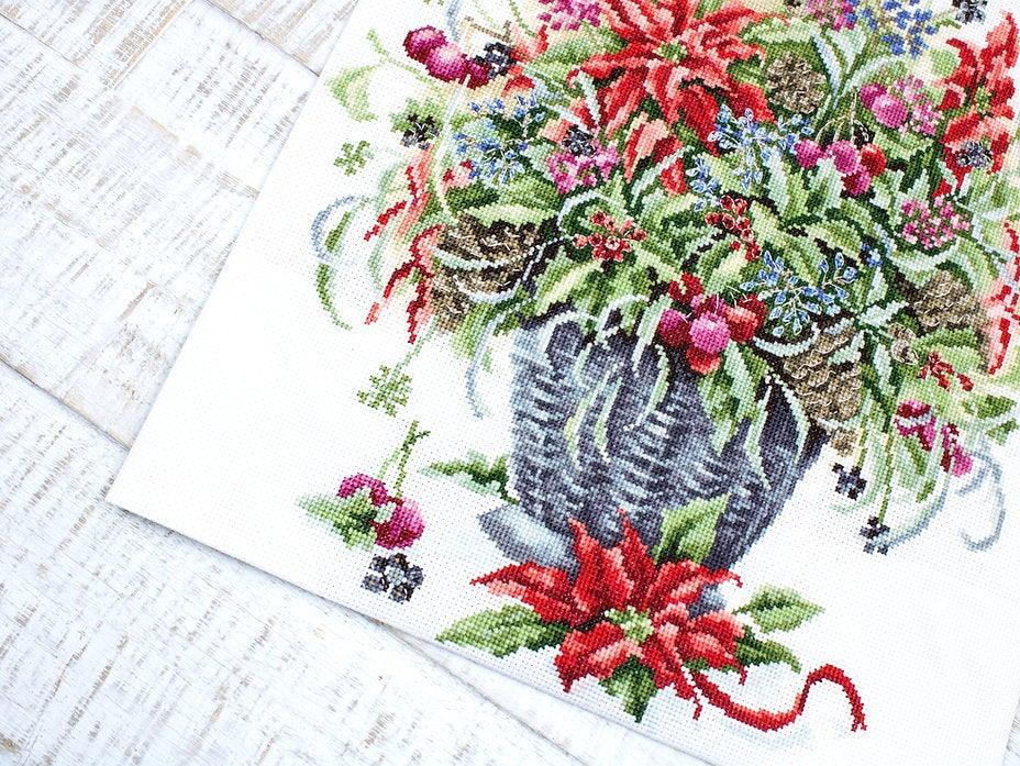 December Bouquet B7002L Counted Cross-Stitch Kit featuring Aida canvas, vibrant threads, and needle for crafting.