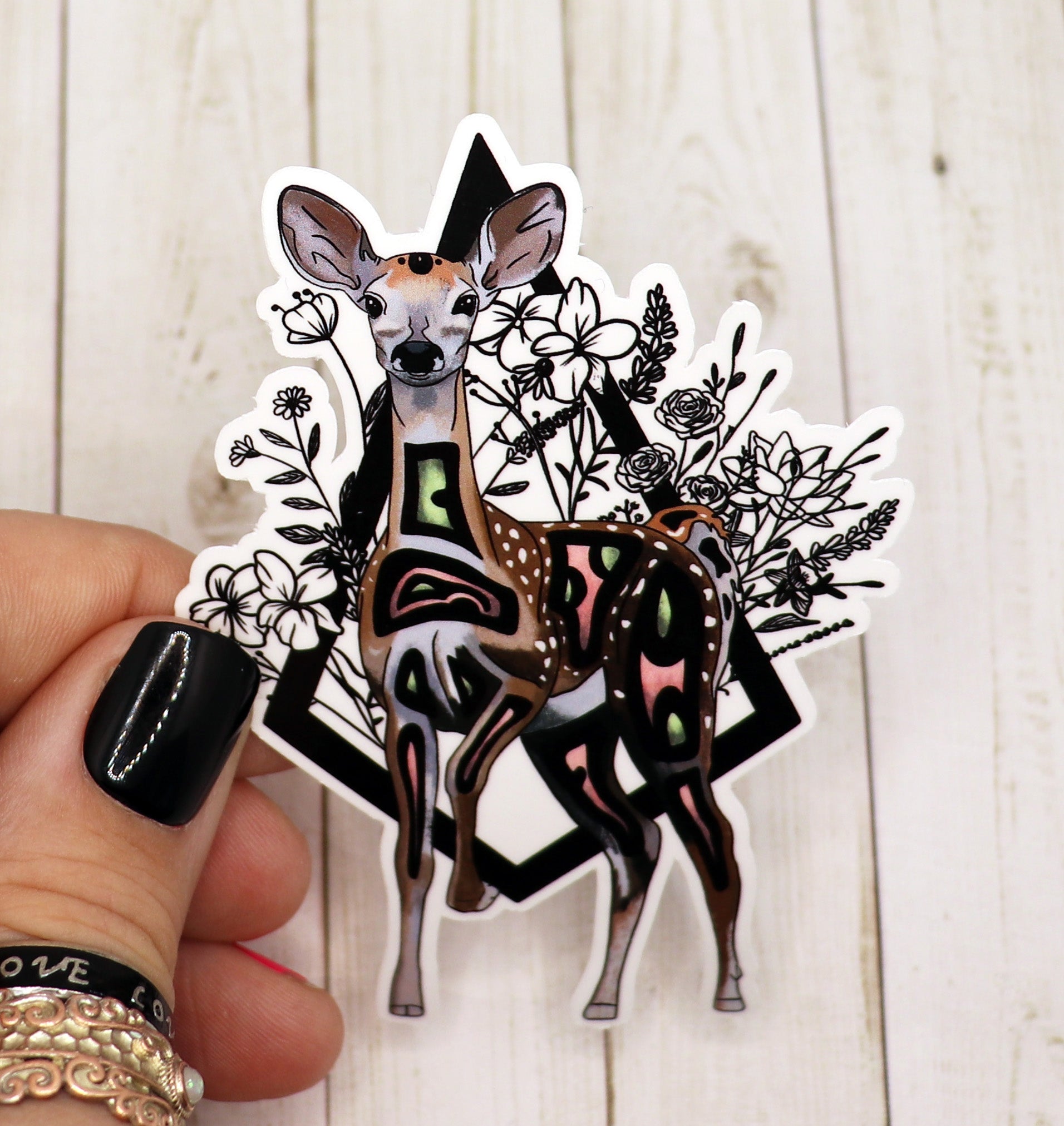 A beautifully designed deer sticker on a matte vinyl surface, showcasing intricate details and vibrant colors.