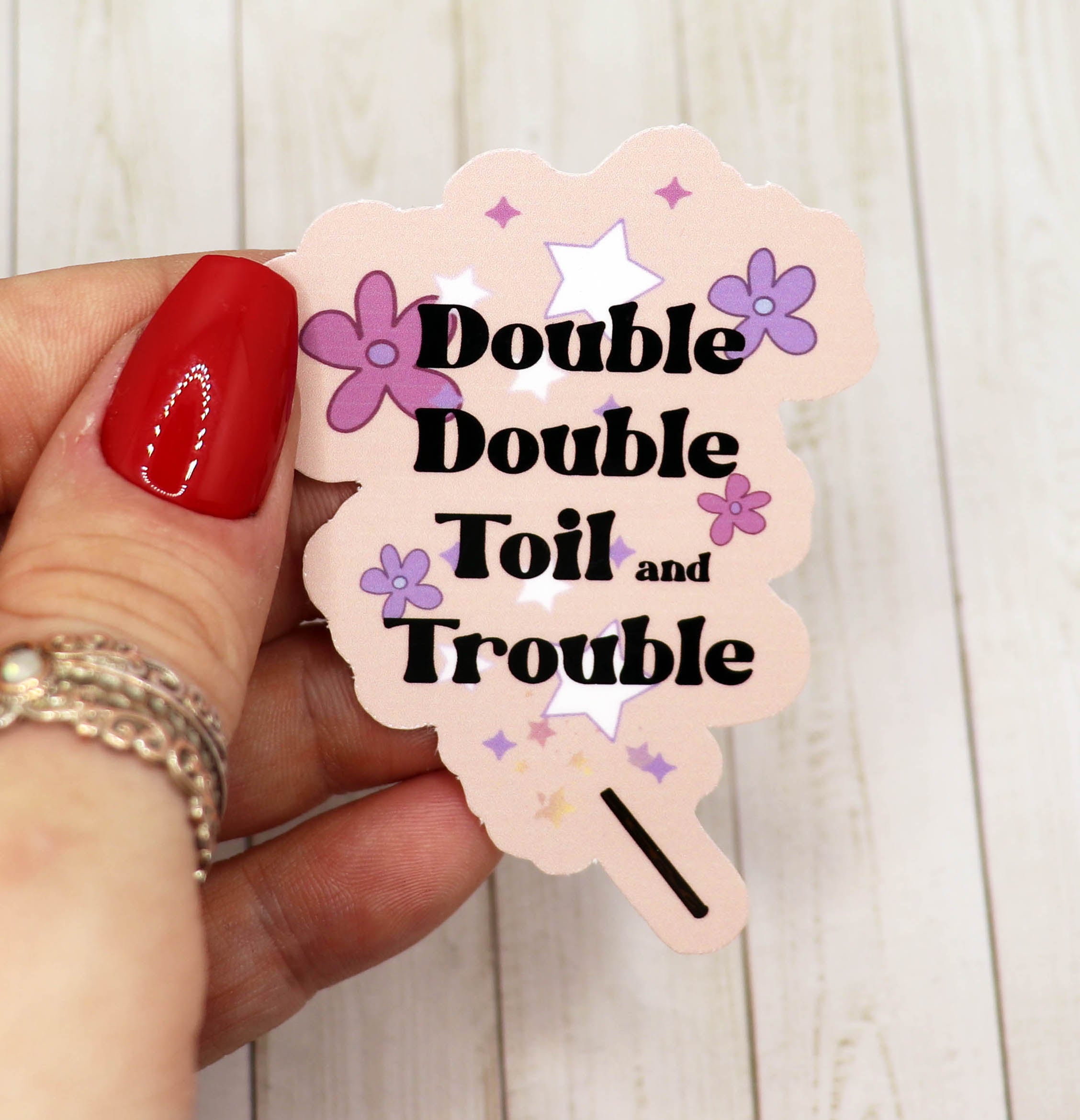 Double Double Toil and Trouble vinyl sticker on a white background, showcasing its vibrant design and matte finish.