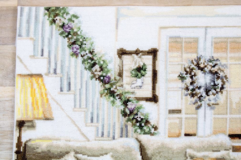 Dreaming of a White Christmas cross-stitch kit featuring Aida canvas, Anchor threads, and a needle, showcasing a snowy holiday scene.