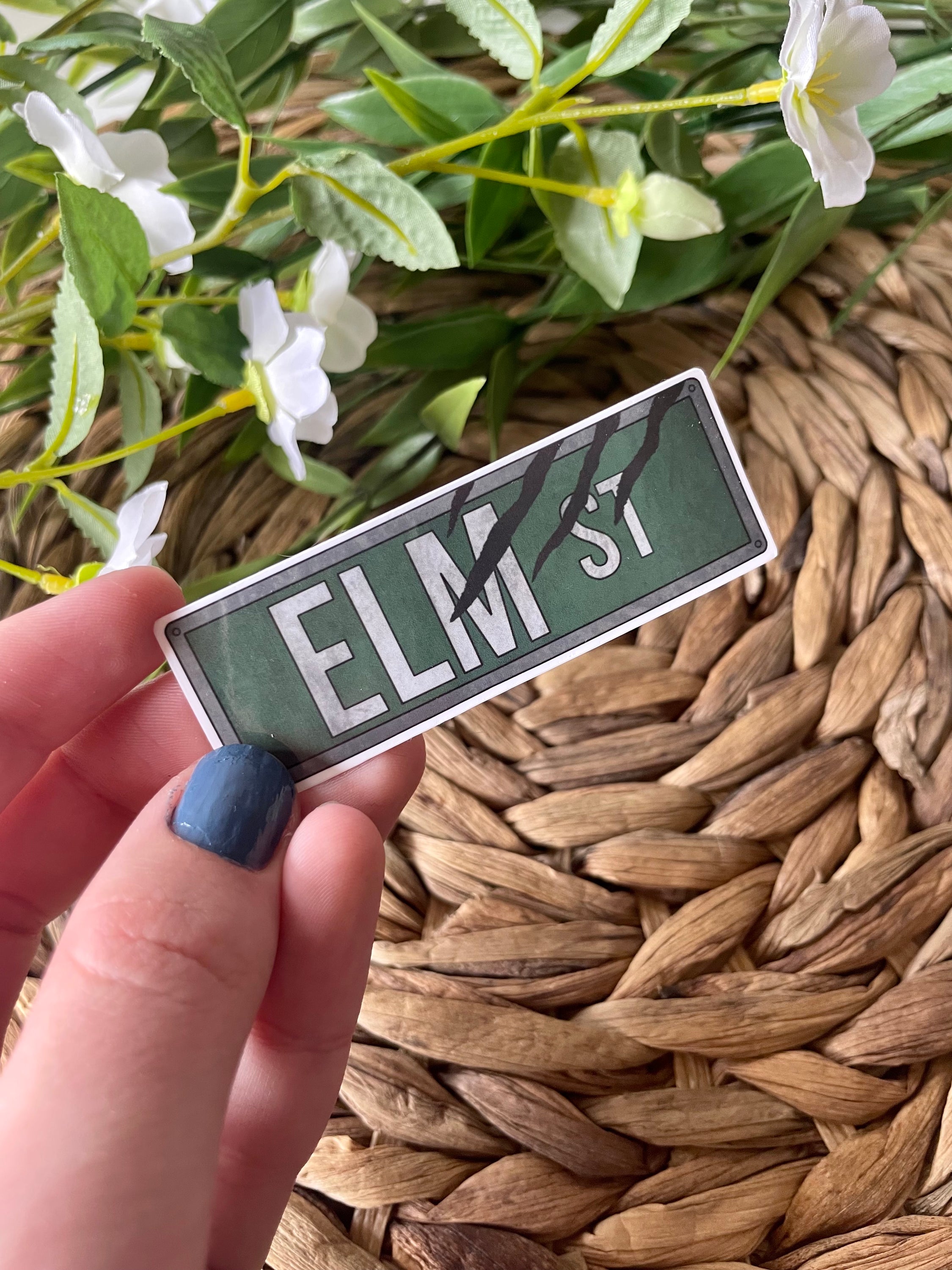 Elm Street Street Sign Sticker featuring iconic design from Nightmare on Elm Street, perfect for personalizing items.