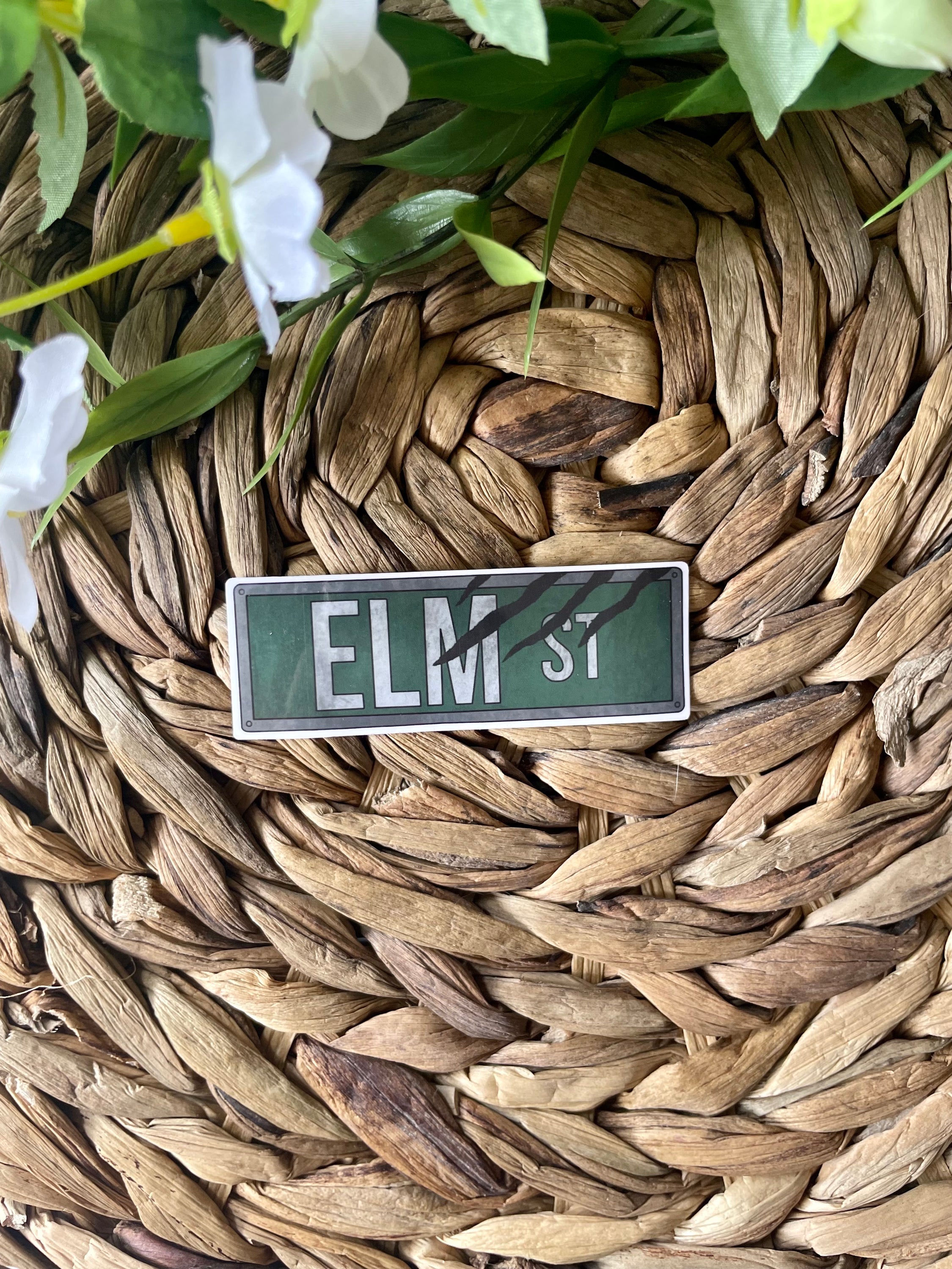 Elm Street Street Sign Sticker featuring iconic design from Nightmare on Elm Street, perfect for personalizing items.