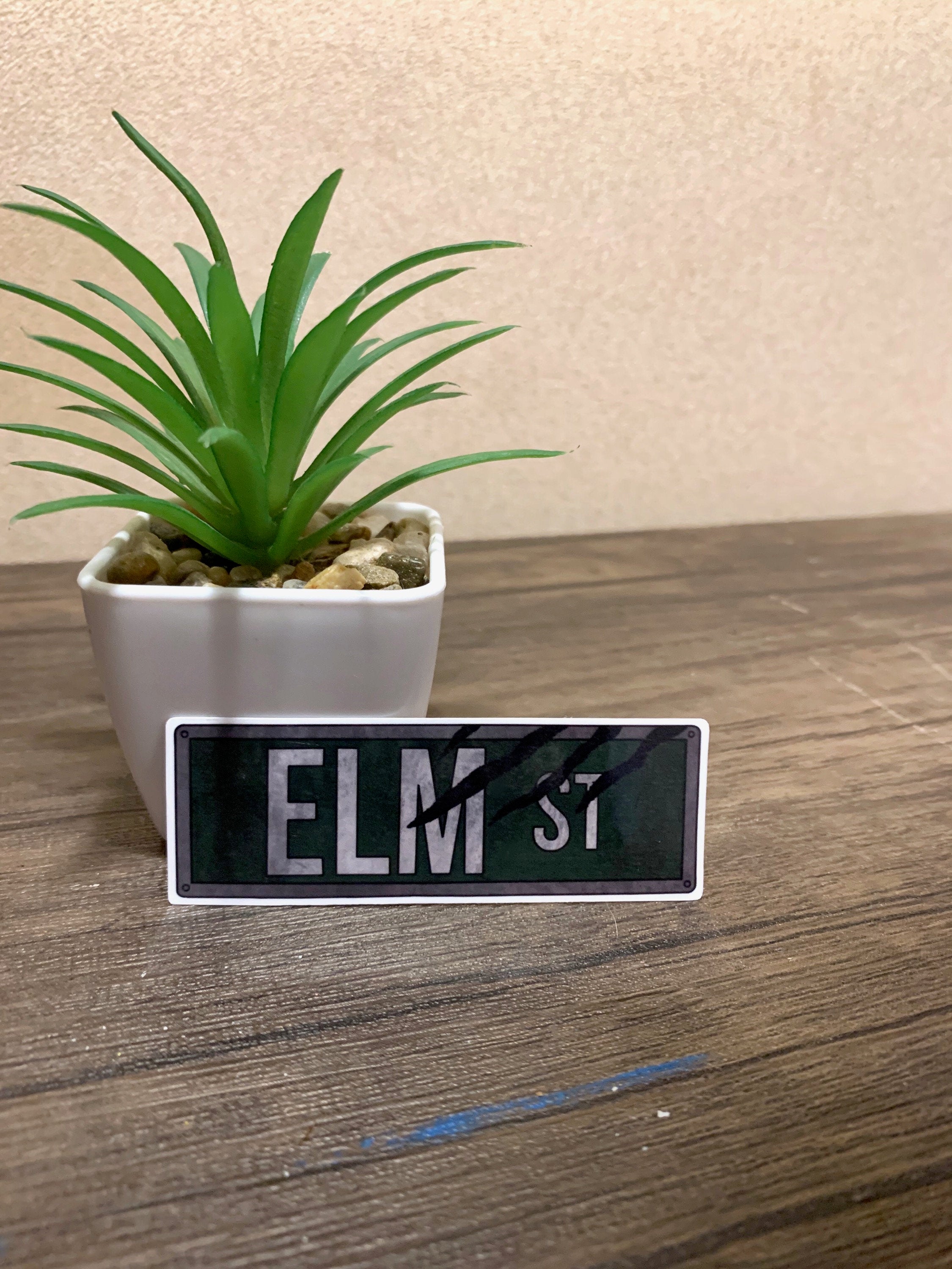 Elm Street Street Sign Sticker featuring iconic design from Nightmare on Elm Street, perfect for personalizing items.