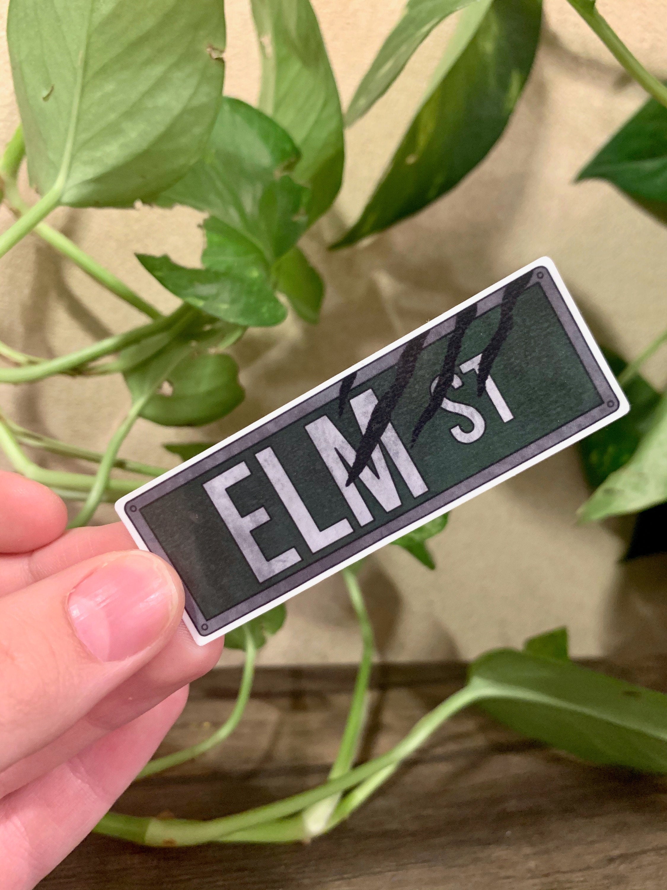 Elm Street Street Sign Sticker featuring iconic design from Nightmare on Elm Street, perfect for personalizing items.