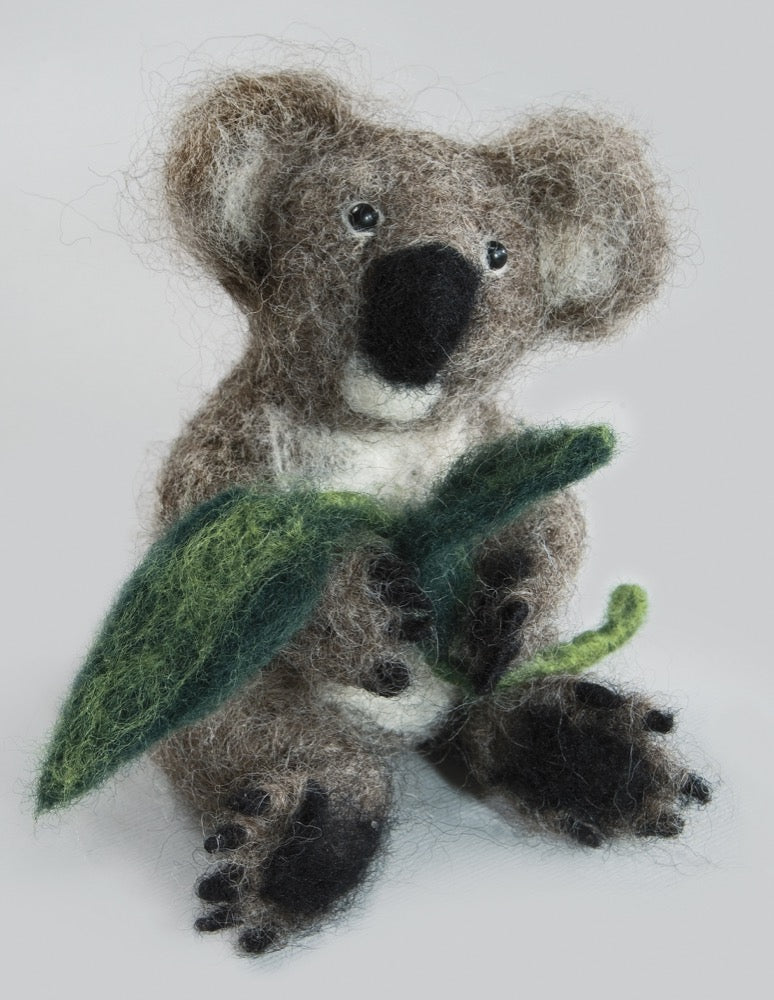 Felting kit V-143C featuring colorful Corriedale wool, felting needles, beads, and instructions for creating a funny koala.