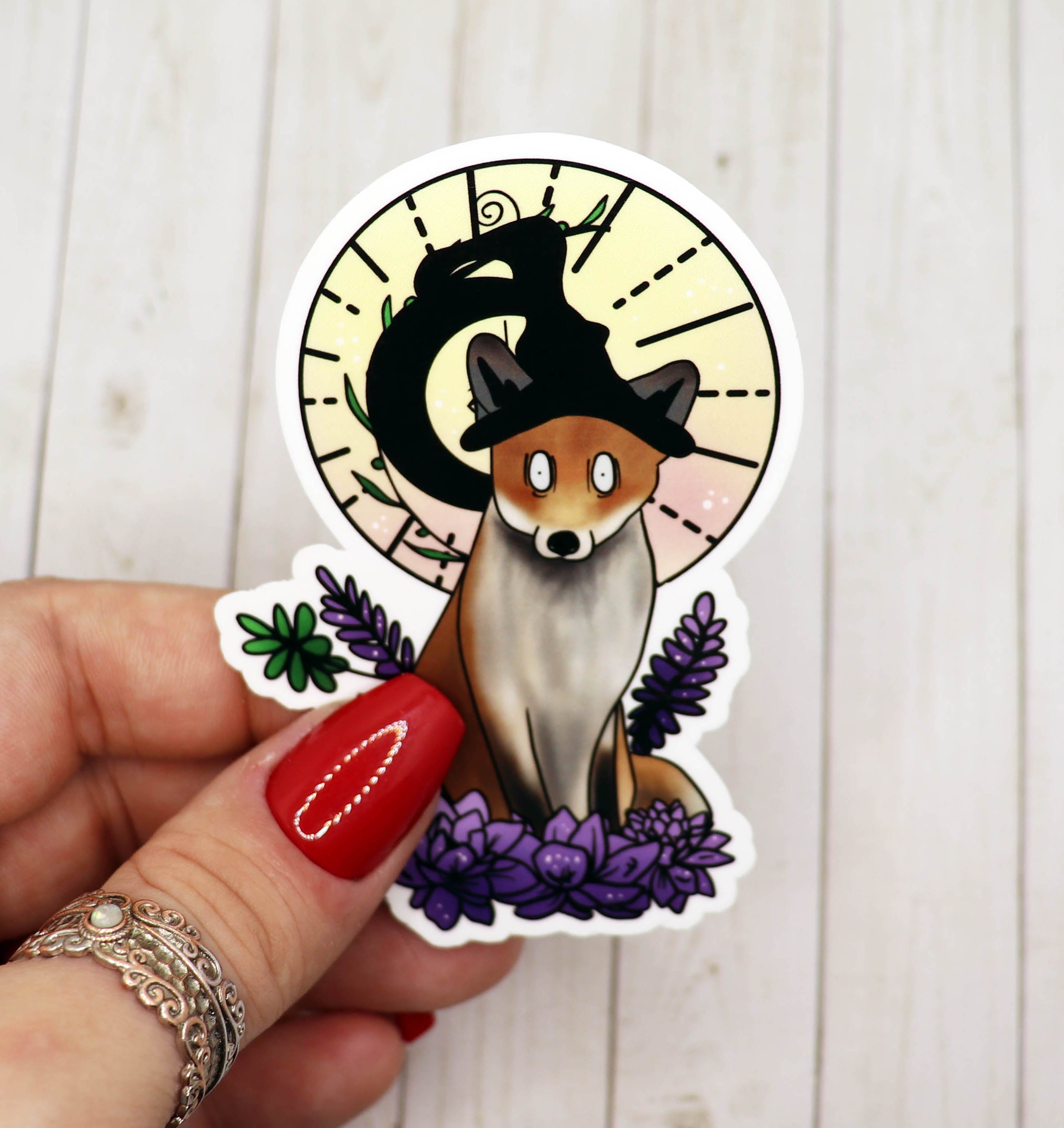 A whimsical Fox Witch Vinyl Sticker featuring a fox with witchy elements, perfect for personalizing various items.