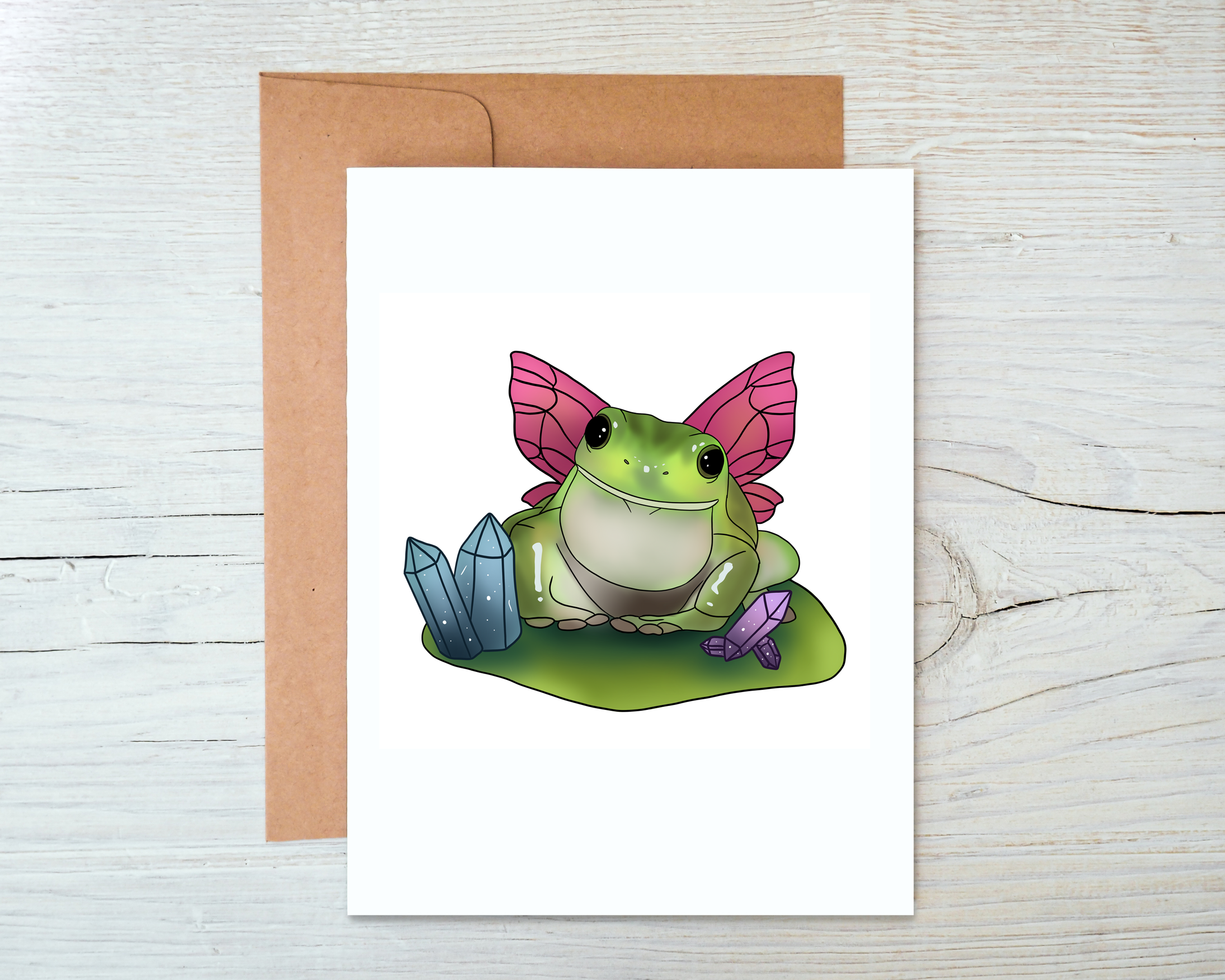 A whimsical Frog Fairy Card featuring a charming design, blank inside, and accompanied by a kraft envelope.