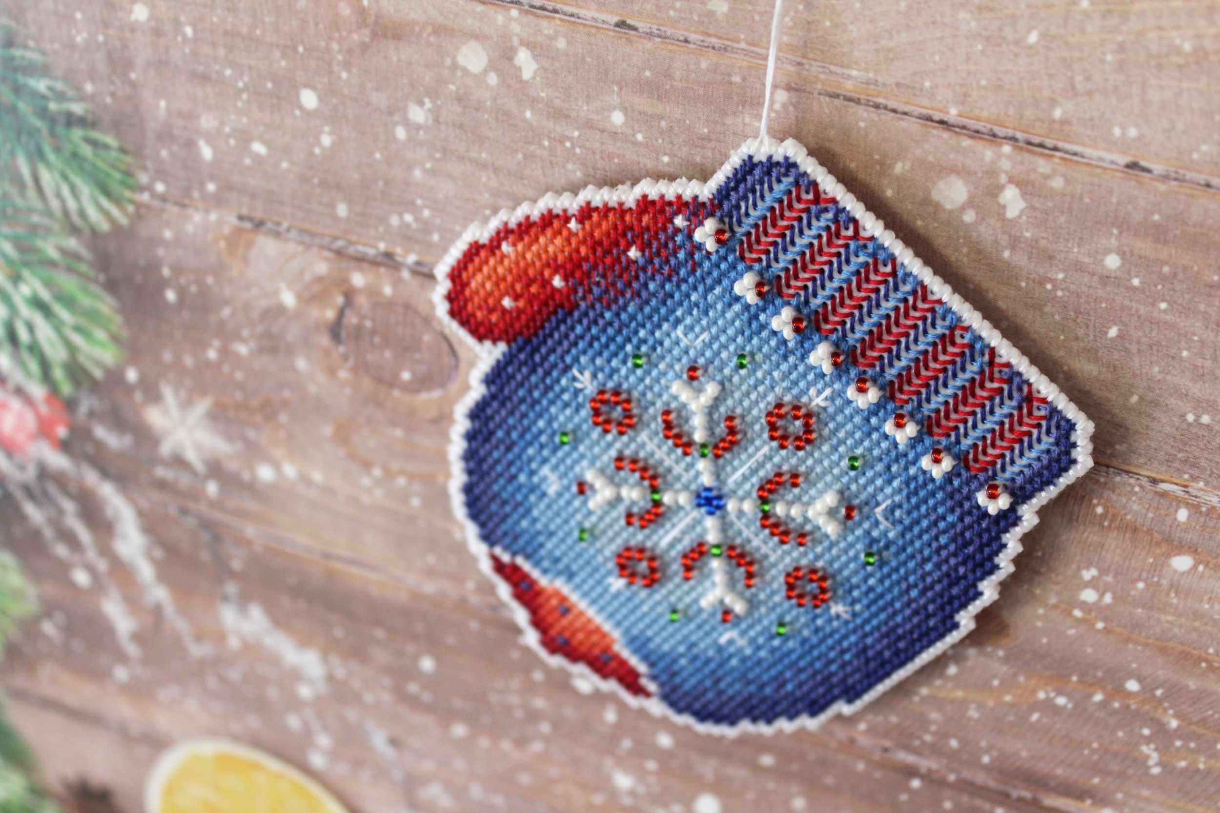 Frosty Mitten SR-457 Plastic Canvas Counted Cross Stitch Kit with colorful threads, beads, and pattern for crafting.