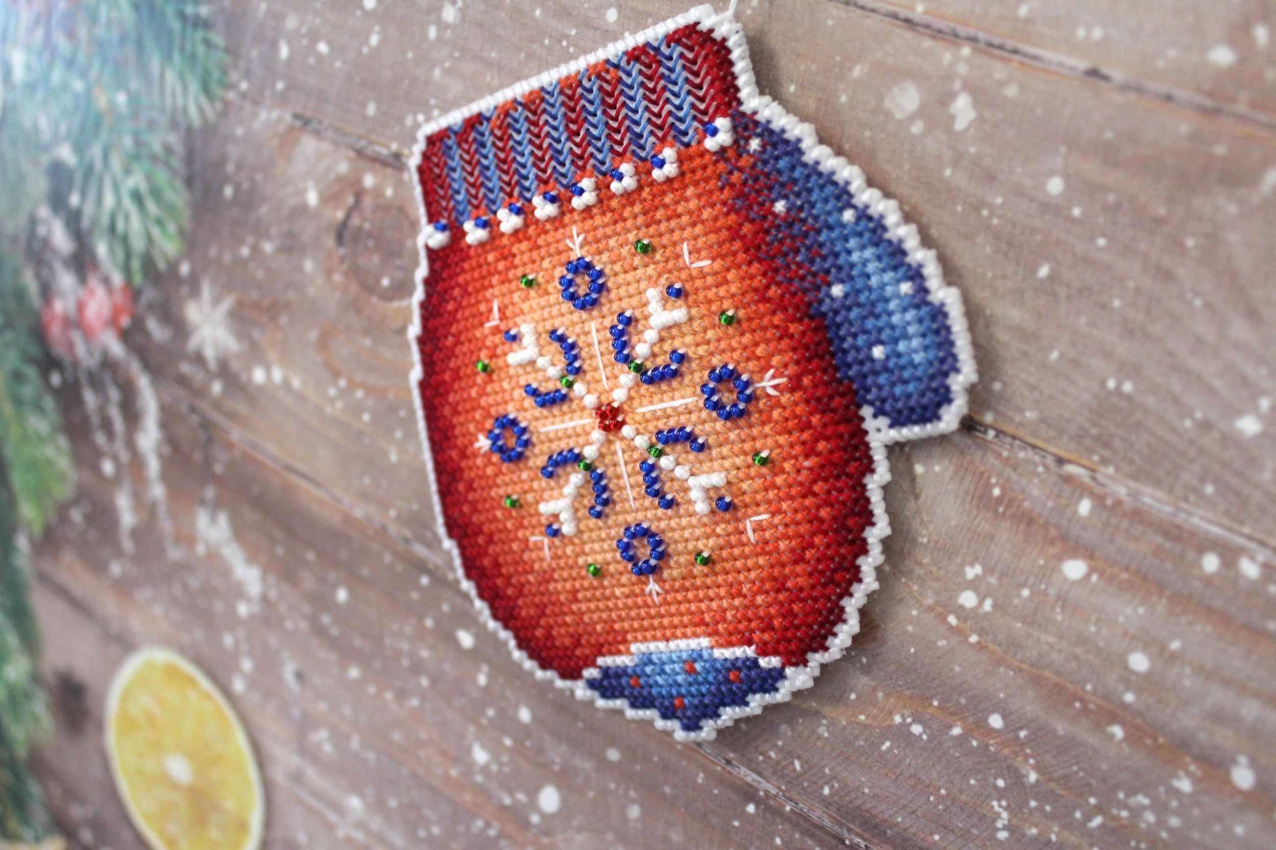 Frosty Mitten SR-457 Plastic Canvas Counted Cross Stitch Kit with colorful threads, beads, and pattern for crafting.