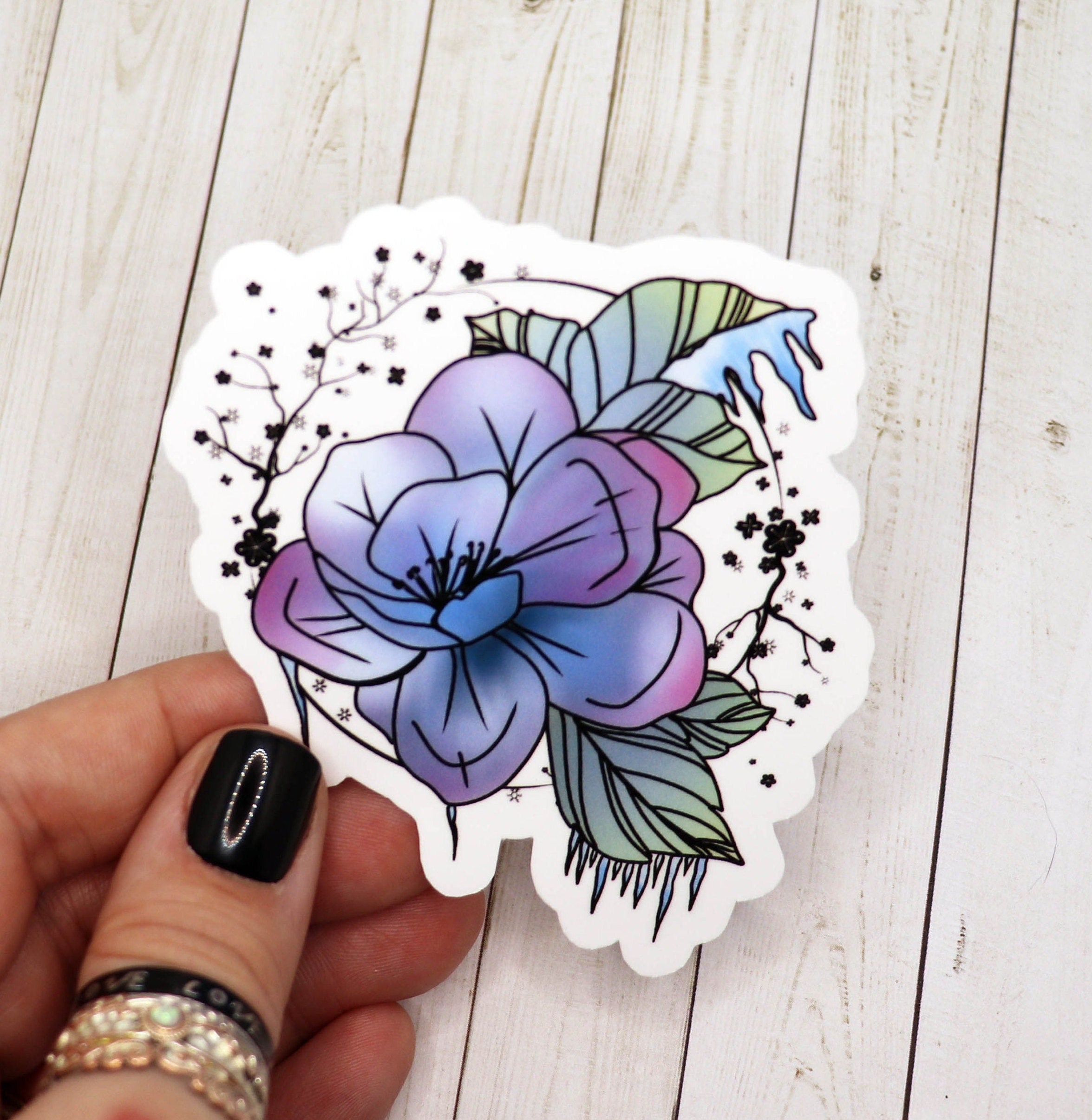 A vibrant Frozen Flower Sticker featuring intricate floral designs on a matte vinyl surface, ideal for personalizing various items.