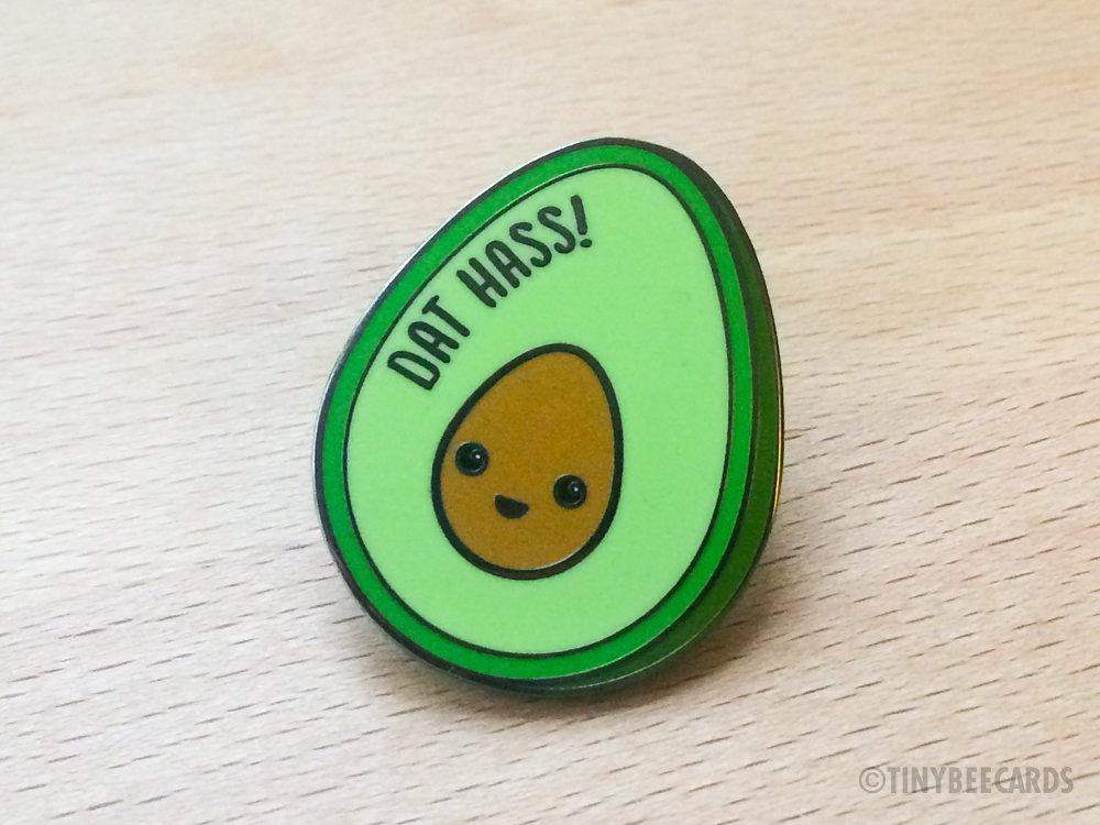 A cute hard enamel pin featuring a kawaii avocado with the pun text 'Dat Hass!' in vibrant colors.