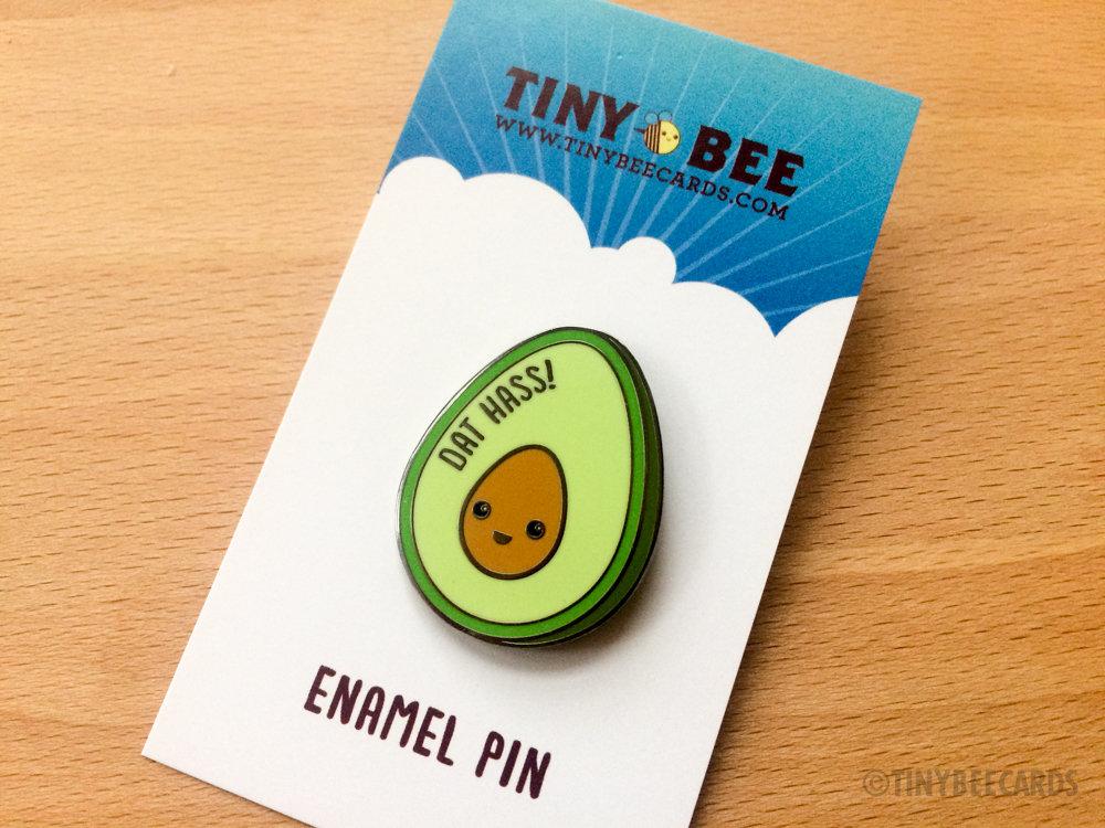 A cute hard enamel pin featuring a kawaii avocado with the pun text 'Dat Hass!' in vibrant colors.