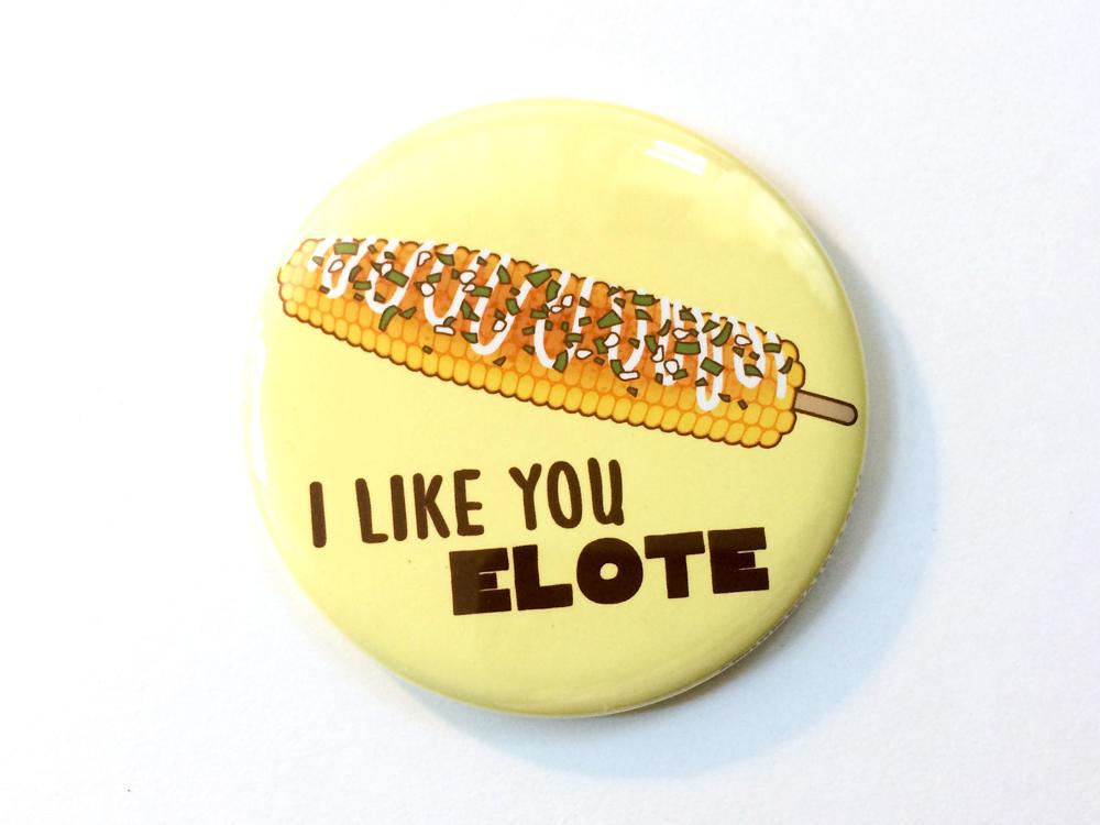 A colorful 2.25-inch round magnet featuring a delicious elote and the text 'I Like You Elote', perfect for gifts and decor.