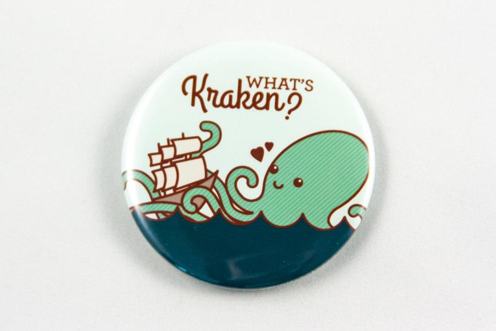 Funny Kraken Magnet or Pin featuring an adorable kraken and ship with the pun 'What's Kraken?'