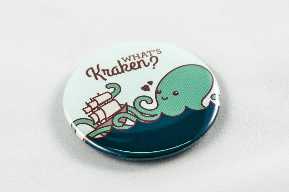 Funny Kraken Magnet or Pin featuring an adorable kraken and ship with the pun 'What's Kraken?'