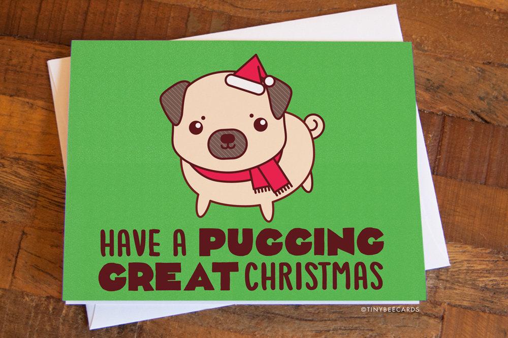 Funny Pug Christmas Card featuring a happy pug in a Santa hat and scarf with the text 'Have a pugging great Christmas!'