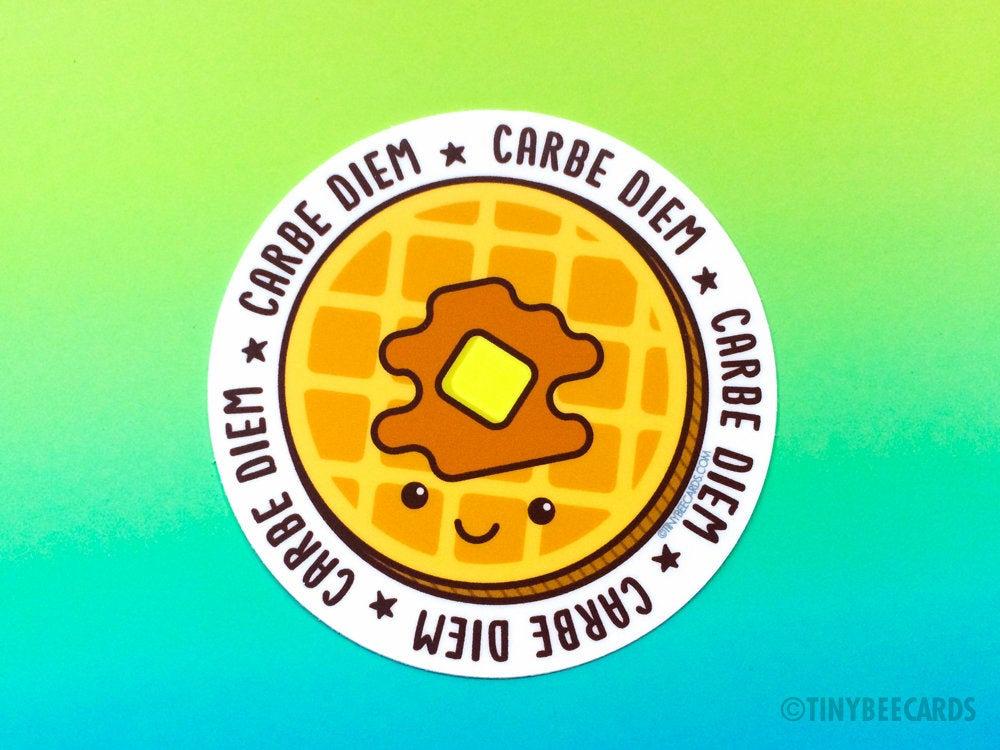 A colorful vinyl sticker featuring a happy waffle with butter and syrup, and the text 'Carbe Diem'.