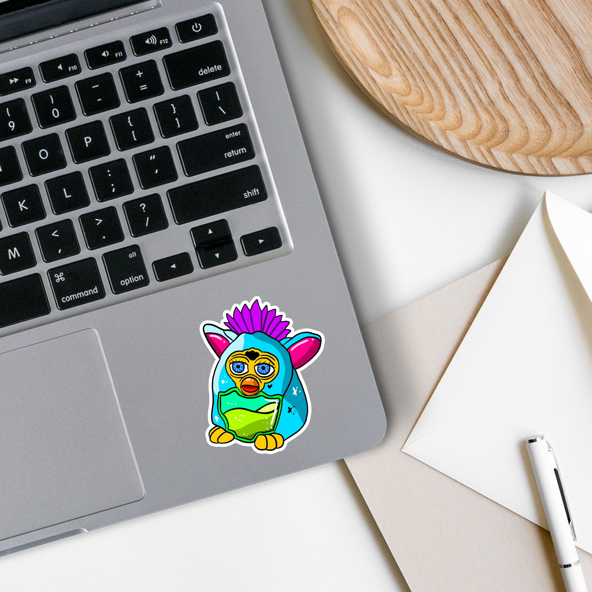 A colorful Furby Vinyl Sticker featuring a playful design, perfect for personalizing various items.