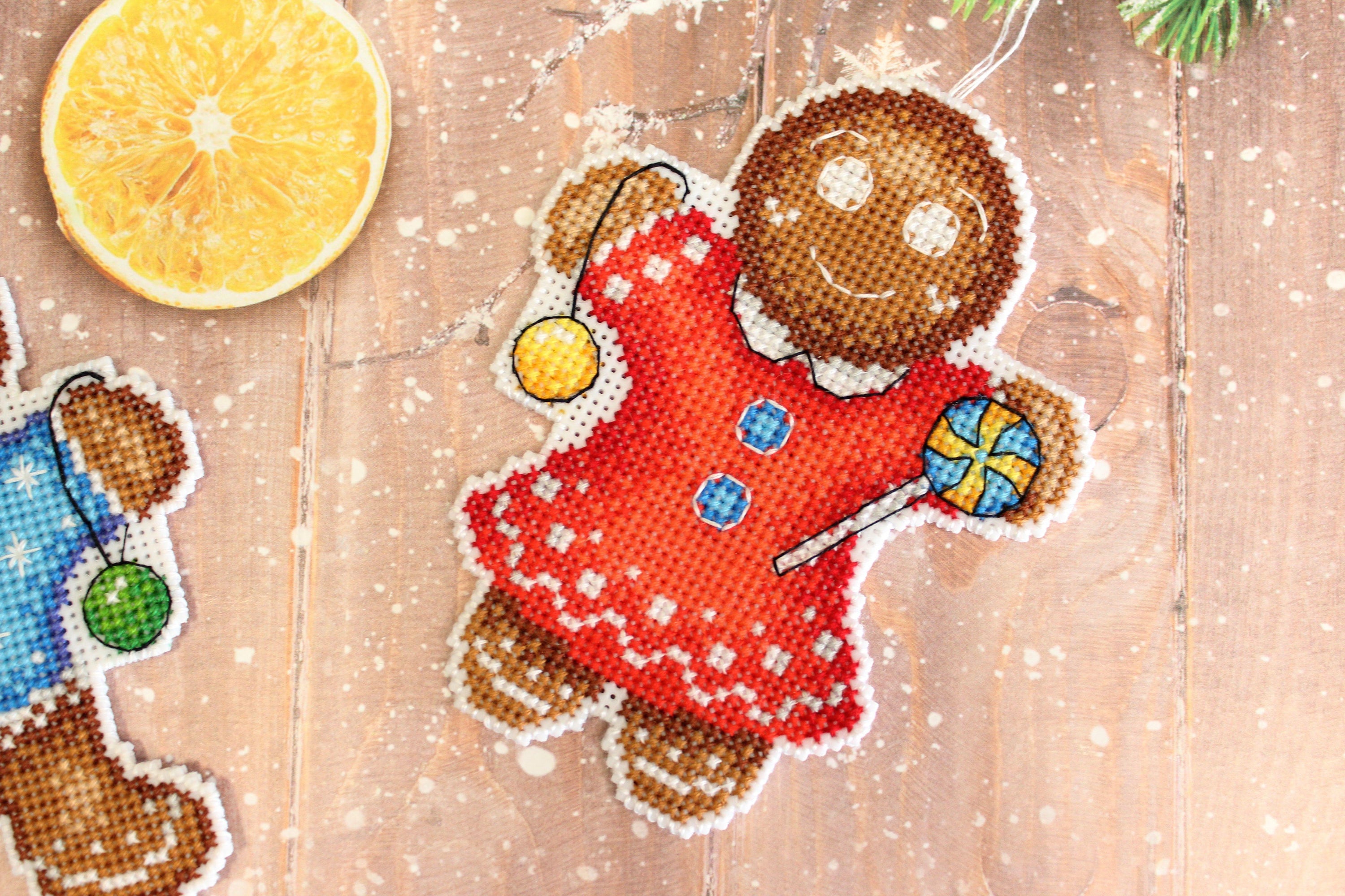 Gingerbread Cookie SR-583 Plastic Canvas Counted Cross Stitch Kit featuring colorful threads and plastic canvas for crafting.