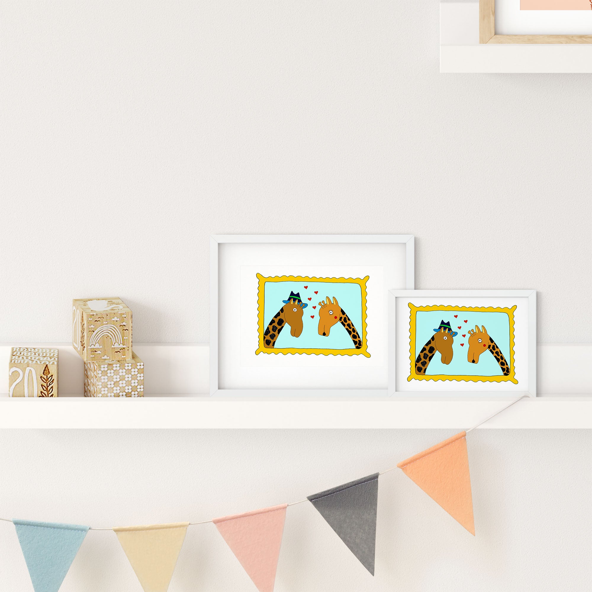 A colorful illustrated print of two giraffes in a framed portrait, showcasing their playful nature.