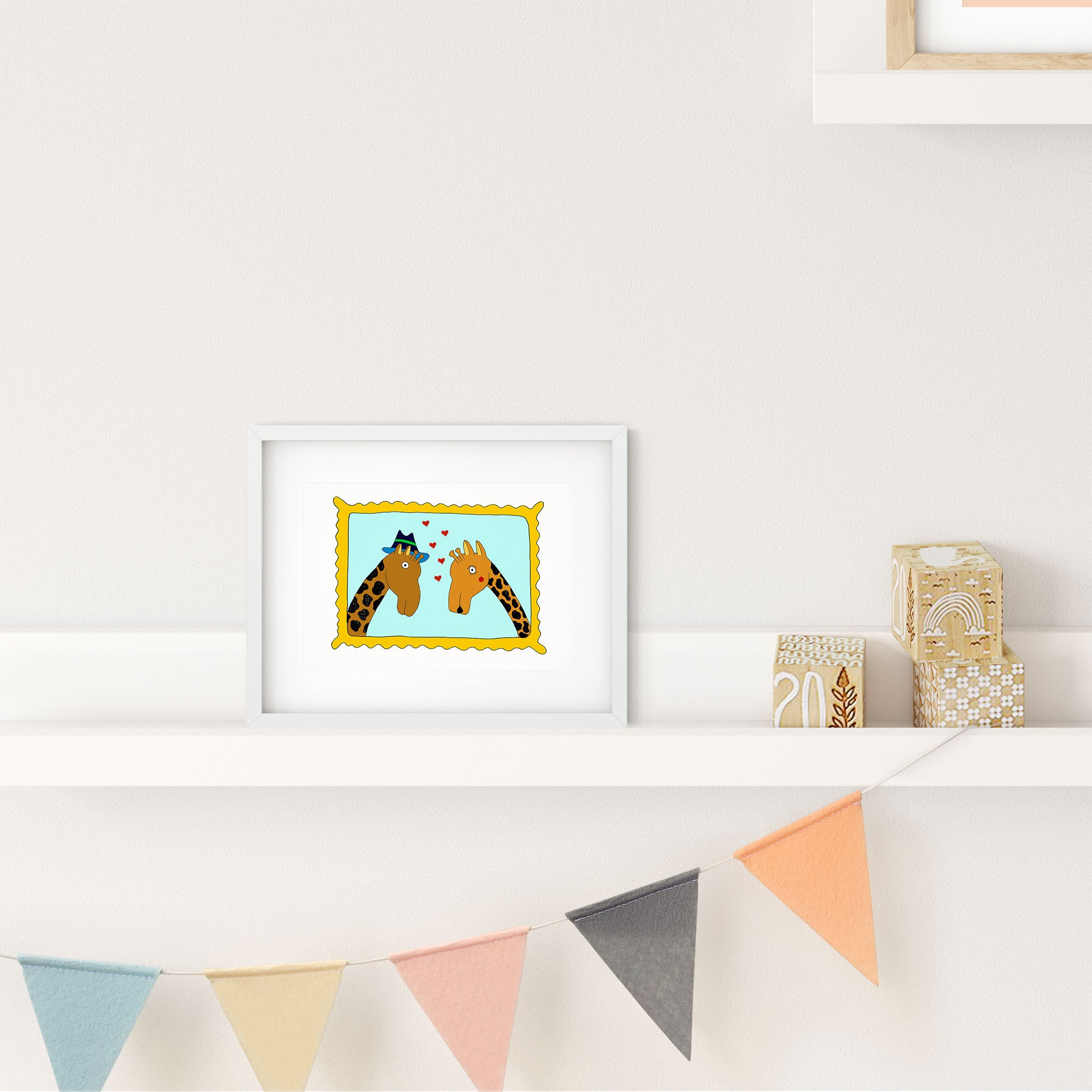 A colorful illustrated print of two giraffes in a framed portrait, showcasing their playful nature.