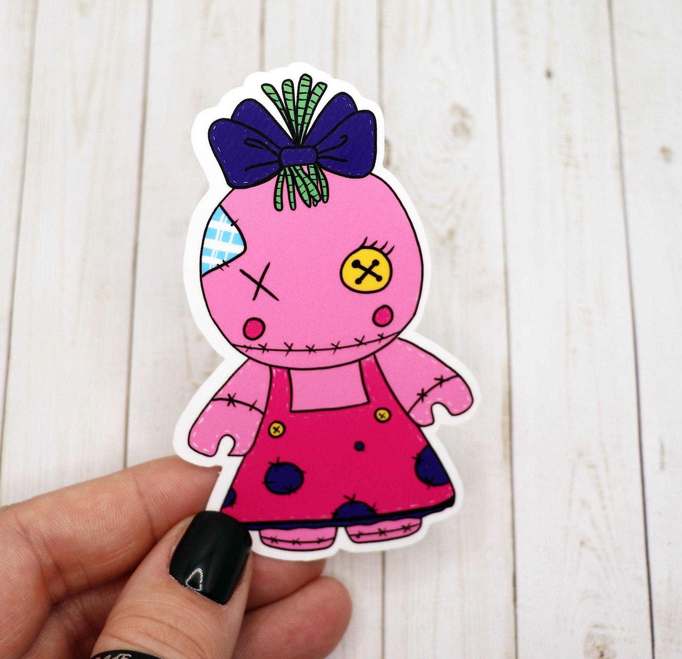 A vibrant Girl Voodoo Doll Sticker featuring a unique design, perfect for personalizing various items.